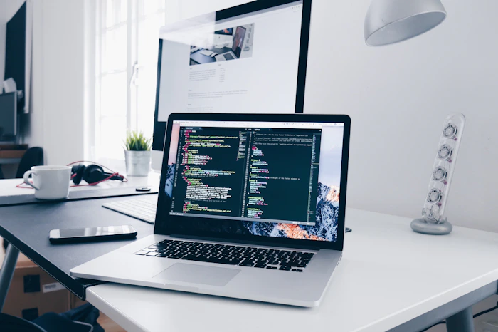 Developer writing code on a laptop
